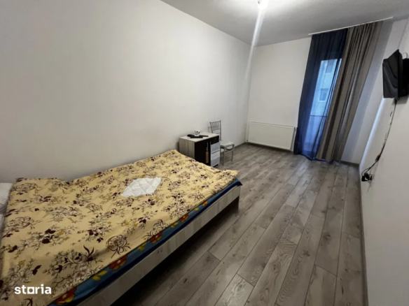 Dormitor în apartament cu două camere, situat în zona Cetății, Florești, Cluj.
